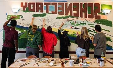 Photo by Ezra Gollan '26 - Students painting a mural in West dining hall